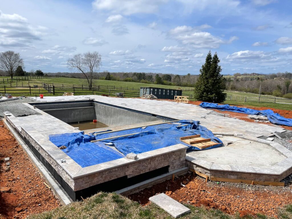 pool under construction with a field in the background