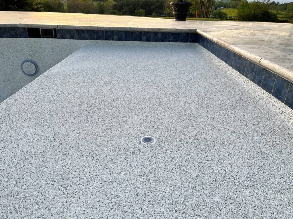 close up view of a pool lounge ledge in a pool that is under construction