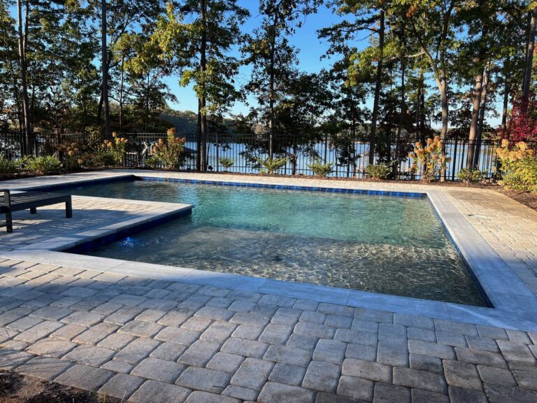 a pool with trees and a fence on lake keowee